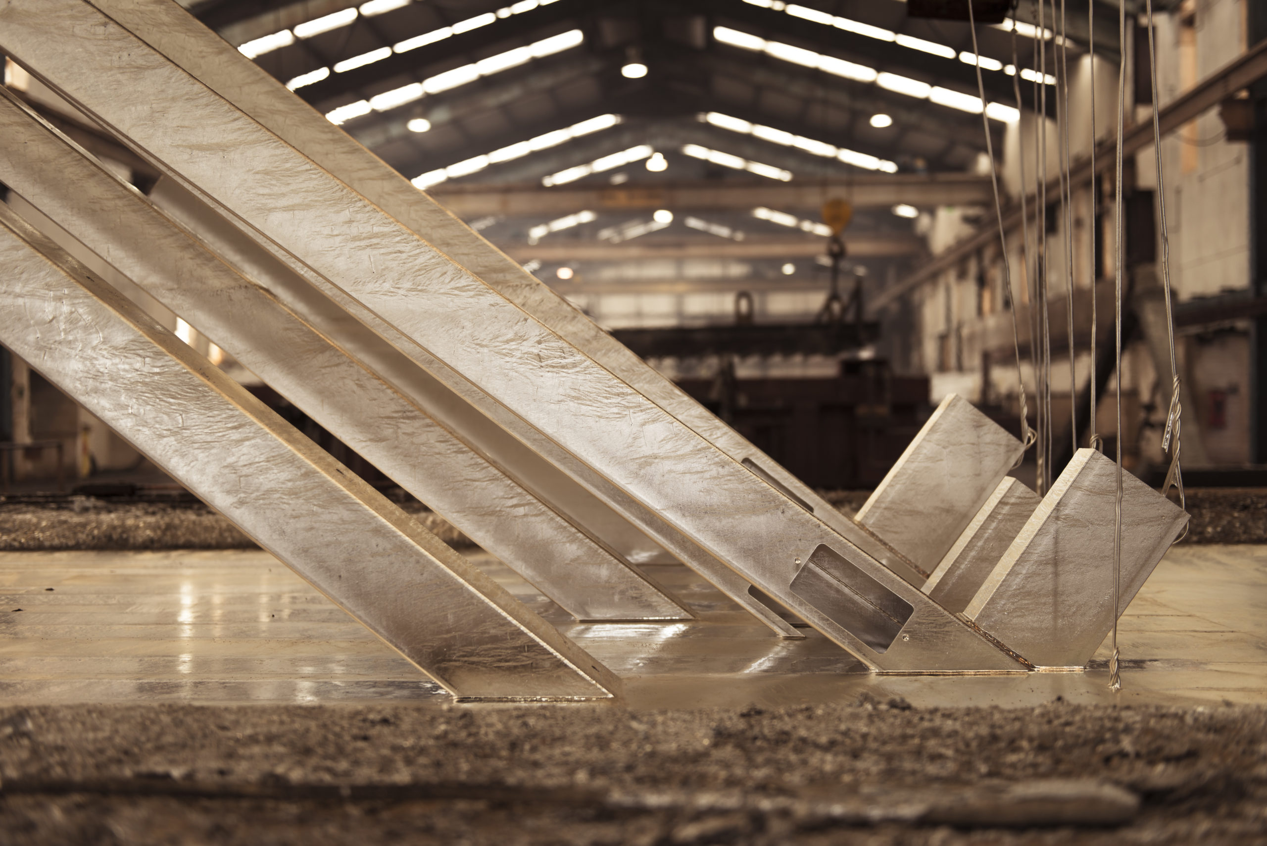 Steel being dipped in molten zinc